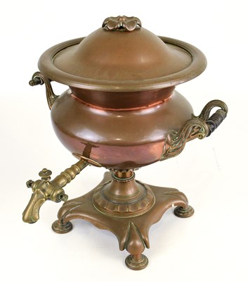 Lot 293 - A 19th century copper twin handled tea urn on...