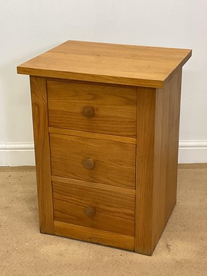 Lot 460 - A modern oak bedside table with three drawers,...