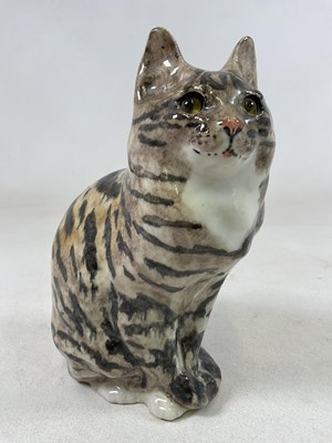 Lot 149 - WINSTANLEY; a large seated tabby cat with...