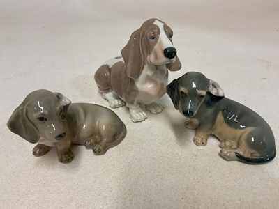 Lot 165 - ROYAL COPENHAGEN; three dogs, boxed basset...