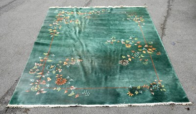 Lot 2683 - A large Chinese superwash green ground carpet,...