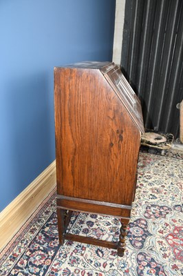 Lot 3073 - A reproduction Priory style oak bureau, width...