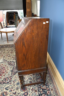 Lot 3073 - A reproduction Priory style oak bureau, width...