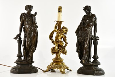 Lot 716 - A gilt metal table lamp modelled as a cherub...