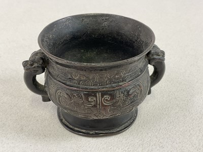 Lot 253 - A Chinese archaic bronze twin handled censer...