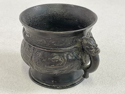 Lot 253 - A Chinese archaic bronze twin handled censer...