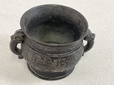 Lot 253 - A Chinese archaic bronze twin handled censer...