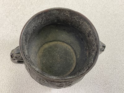 Lot 253 - A Chinese archaic bronze twin handled censer...
