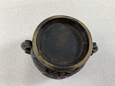 Lot 253 - A Chinese archaic bronze twin handled censer...