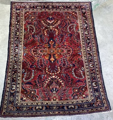 Lot 364 - A large Persian wool  rug, in deep red...