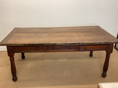 Lot 400 - A large oak plank topped kitchen table with a...