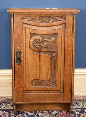 Lot 3014 - An Arts and Crafts oak hanging cupboard with...