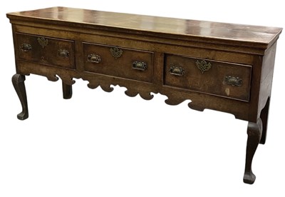 Lot 23 - A late 19th century oak three drawer dresser...