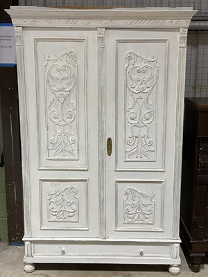 Lot 394 - A French painted armoire with two carved panel...