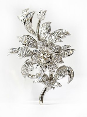 Lot A white metal brooch in the form of flower and...