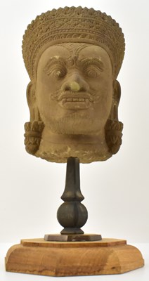 Lot 1070 - An antique Cambodian sandstone head, the head...