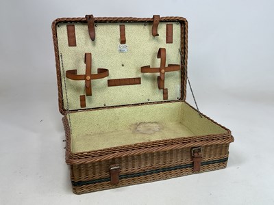 Lot 26 - HARRODS; a wicker hamper with metal carrying...