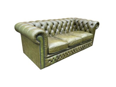 Lot 30 - A green leather three seater Chesterfield sofa,...