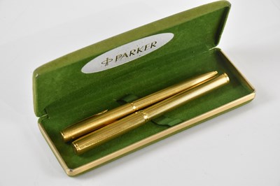 Lot 565 - DUNHILL; a gold plated fountain pen and roller...