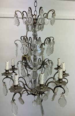 Lot 337 - A French brass and clear cut glass chandelier,...