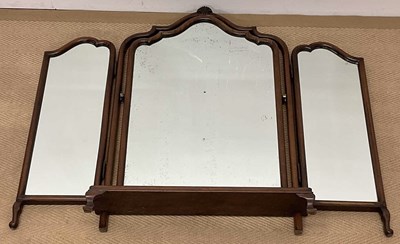 Lot 509 - A walnut triptych mirror, raised on scrolling...