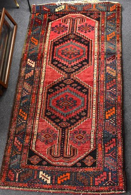 Lot 102 - An Afghan rug with central lozenge and two...