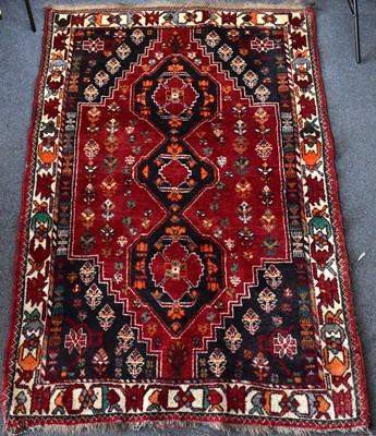 Lot 106 - A Caucasus-style rug with three central guls...