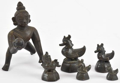 Lot 1033 - A small Indian bronze figure of crawling...