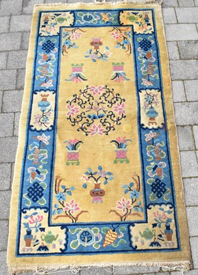 Lot 95 - A 20th century Chinese rug with central apple...