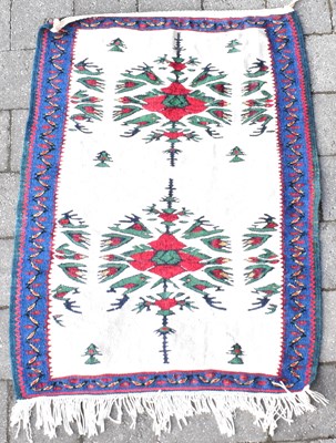 Lot 94 - A Far Eastern saddle rug with double floral...