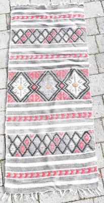 Lot 93 - A Far Eastern woven saddle rug with geometric...