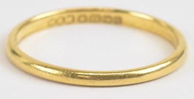 Lot 1304 - A 22ct gold thin band ring, size L, approx 1.7g.