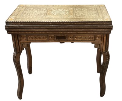 Lot 21 - An Eastern fold-over card table, profusely...