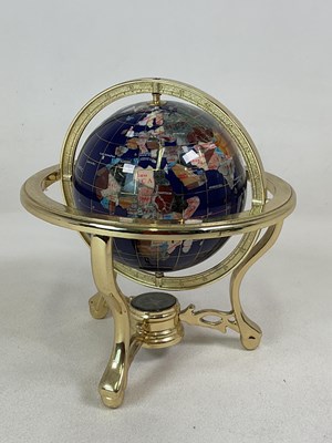 Lot 31 - A brass gimbal mounted polished hardstone...