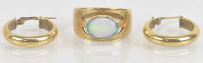 Lot 1459 - A yellow metal opal set ring, the central opal...