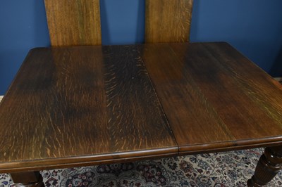 Lot 2975 - An Edwardian oak extending dining table, with...