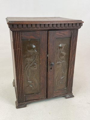 Lot 13 - An Art Nouveau oak smoker's cabinet with...