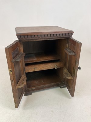 Lot 13 - An Art Nouveau oak smoker's cabinet with...