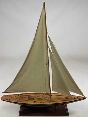 Lot 79 - A teak model of a yacht with linen sails,...