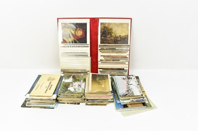 Lot 404 - A red album of mixed postcards including some...