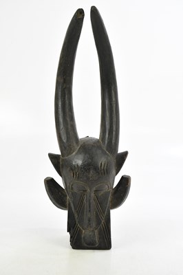 Lot 584 - A Senufo fire spitter mask, height 43cm.