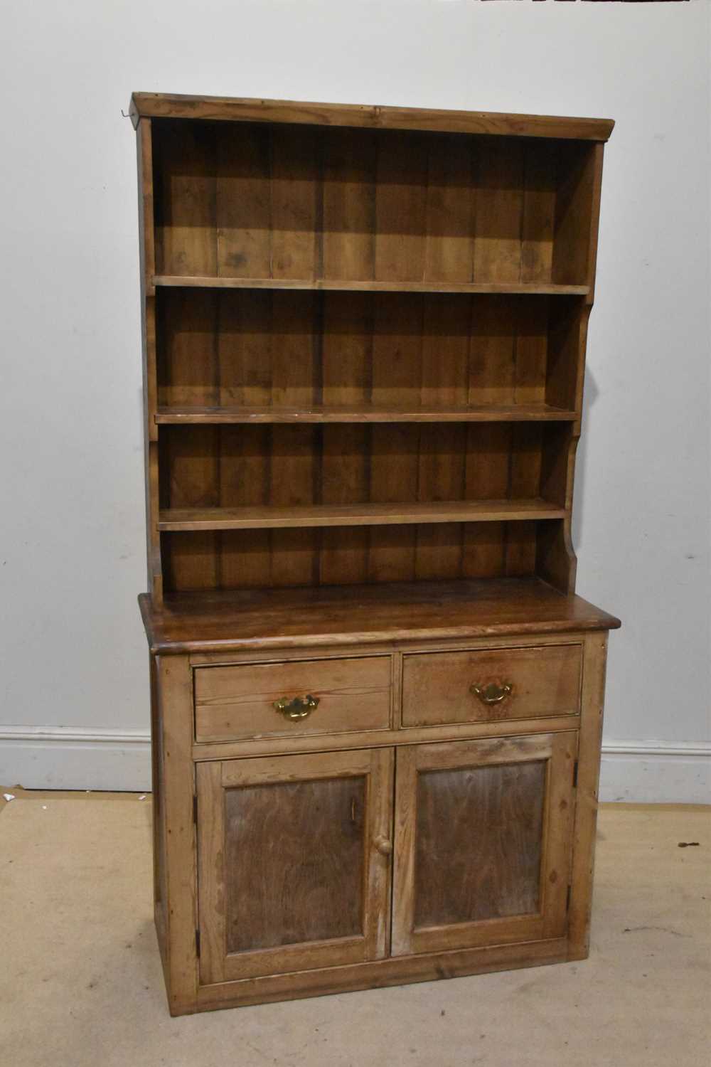 Lot 1042 - An old pine dresser, with boarded plate rack...