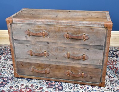 Lot 3050 - A modern leather mounted pine chest of three...