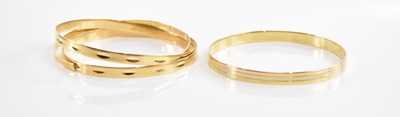 Lot 203 - Four yellow metal bangles, each stamped either...