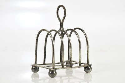 Lot 1356 - A white metal four section toast rack.