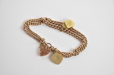 Lot 216 - A 9ct rose gold double Albertina, suspending a...