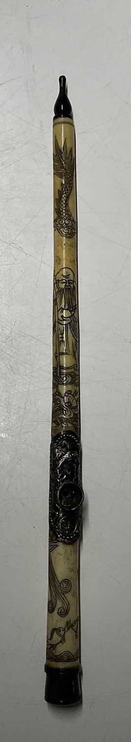 Lot 390 - A Chinese bone opium pipe, 47cm, decorated...