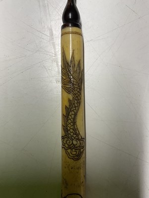 Lot 390 - A Chinese bone opium pipe, 47cm, decorated...