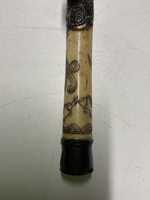 Lot 390 - A Chinese bone opium pipe, 47cm, decorated...