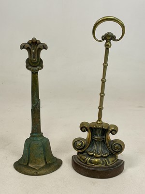 Lot 223 - A 19th century brass scroll doorstop with a...